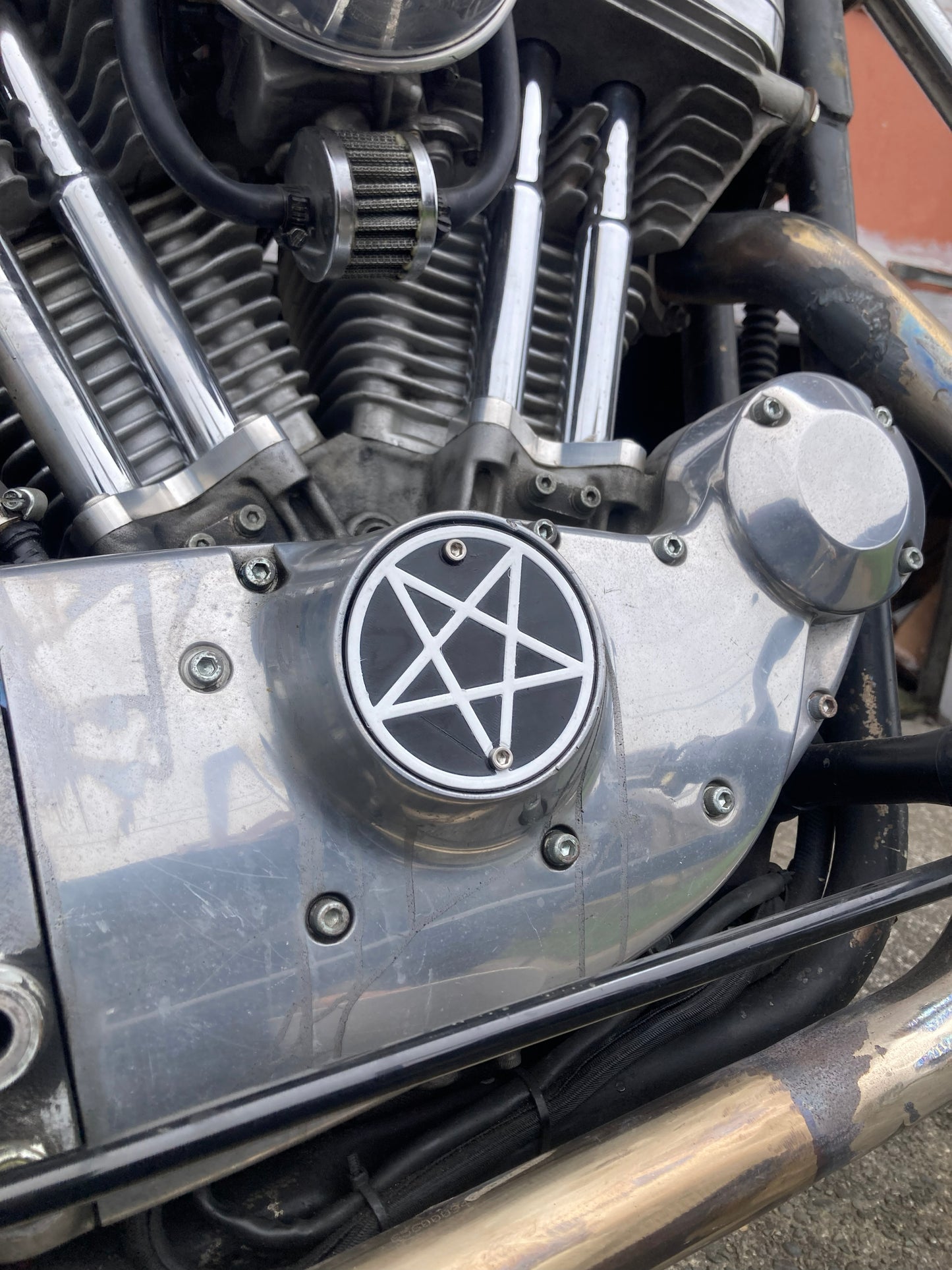 Custom 3D printed Sportster timing cover with cross and chain design for Harley-Davidson.